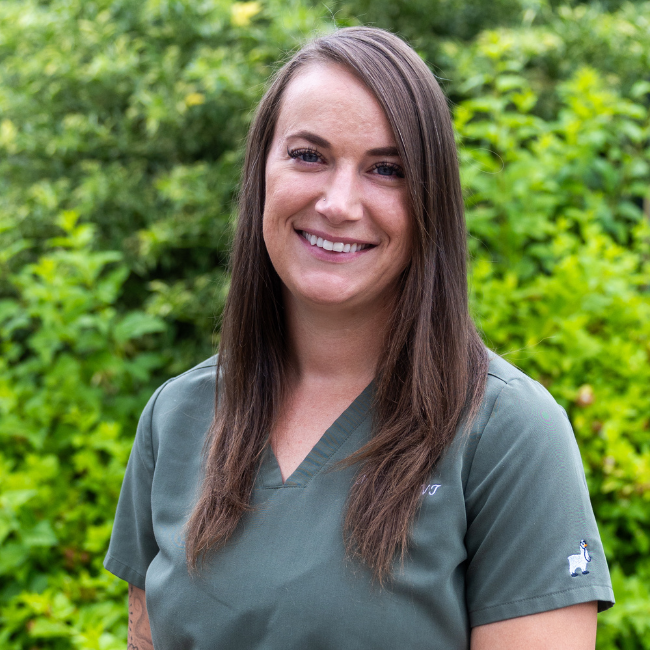 Mel Arnold, registered veterinary technician at Carbondale Animal Hospital, wearing green scrubs